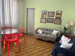 a living room with a couch and a table and chairs at Casa aconchegante Barroca in Belo Horizonte
