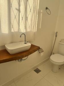 a bathroom with a sink and a toilet at Casa aconchegante Barroca in Belo Horizonte +11 photos