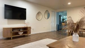 a living room with a flat screen tv on the wall at Venice-Manasota Key Getaway in Venice
