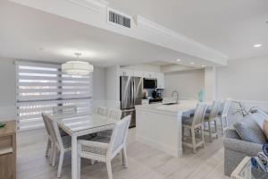 a kitchen and dining room with a table and chairs at Sundial K402 - Executive Beach View Two Bedroom Penthouse at Sundial Sanibel in Sanibel