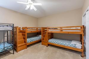 three bunk beds in a room with a ceiling fan at Private Pool Vacation Home in Lake Ozark +49 photos