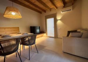 a living room with a table and chairs and a television at La Plana allotjament rural in Aviá