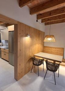 a dining room with a table and two chairs at La Plana allotjament rural in Aviá