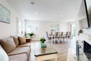 a living room with a couch and a table at Sunny Days in Newport Heights