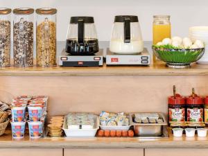 a shelf with food and appliances on it at ibis budget Duisburg City am Innenhafen in Duisburg