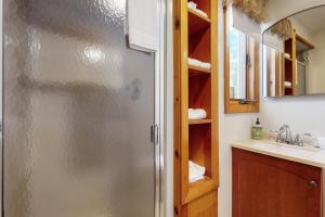 a bathroom with a stainless steel refrigerator and a sink at Bayside Sunshine in Ossipee +60 photos