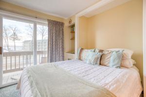 a bedroom with a bed and a large window at Misty Harbor Resort - Unit 103 in Dockham Shore