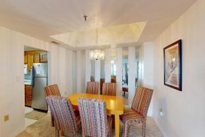 a dining room with a yellow table and chairs at Citadel 3626 in Sugar Mountain