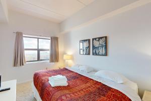 a bedroom with a bed with a red blanket and a window at Citadel 3626 in Sugar Mountain +34 photos