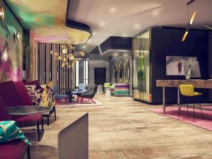 a lobby with chairs and tables in a room at MERCURE Hotel Berlin Wittenbergplatz in Berlin