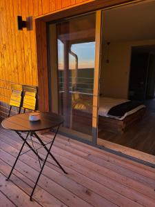 a room with a bed and a table on a deck at Villa K in Oberlauterbach