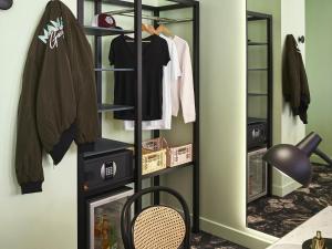 a walk in closet with a black shelving unit at Mama Shelter Roma in Rome +157 photos