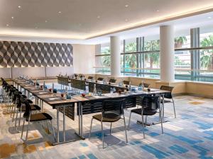 a large conference room with a long table and chairs at Pullman Jakarta Indonesia in Jakarta
