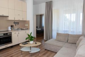 a living room with a couch and a table at Boró Apartman in Tiszafüred