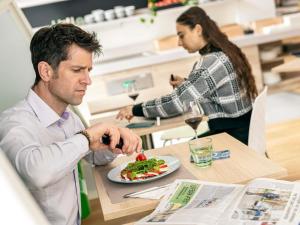a man sitting at a table with a plate of food at ibis Styles Strasbourg Stade de la Meinau in Strasbourg +85 photos