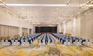 a large room with rows of chairs and a stage at Holiday Inn Shanghai Minhang Center by IHG in Shanghai +17 photos
