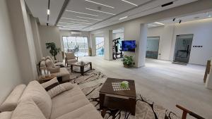 a living room with a couch and a table at Villa from Al Essam Development with private pool, jacuzzi and home cinema المجلس من ال عصام للتطوير مع المسبح والجاكوزي الخاص والهوم سينما in 6th Of October