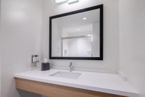 a bathroom with a white sink and a mirror at Garner Hotel Lincoln North by IHG in Lincoln +92 photos