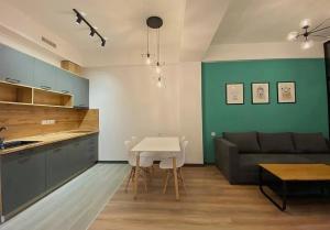 a living room with a couch and a table at ''Malibu'' Apartment with 2 Bedrooms and Open Balcony, Yerevan CITY CENTER-Buzand Street in Yerevan +17 photos