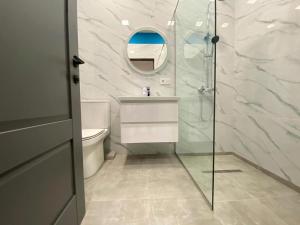 a bathroom with a toilet and a sink and a mirror at ''Malibu'' Apartment with 2 Bedrooms and Open Balcony, Yerevan CITY CENTER-Buzand Street in Yerevan