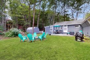 a yard with chairs and a table and a house at Old Orchard Beach House in Old Orchard Beach