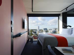 a hotel room with a bed and a large window at Tribe Perth Kings Park in Perth +75 photos