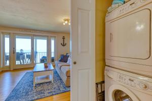 a living room with a washer and dryer at Scouten Beachfront in Old Orchard Beach