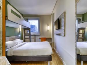 Un pat sau paturi într-o cameră la ibis budget BH Savassi