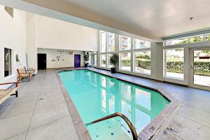 a large swimming pool in a building with windows at Belltown Escape in Seattle