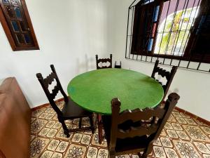 una mesa verde y sillas en una habitación en Refugio das Estações Iguaba Grande, en Iguaba Grande
