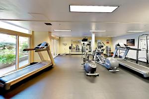 a gym with treadmills and machines in a room at Belltown Escape in Seattle