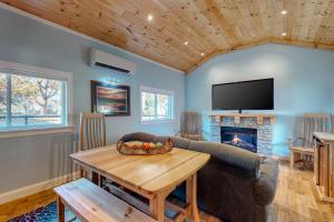 a living room with a couch and a table and a tv at Riverbank Place in Moody