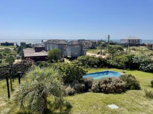 a resort with a swimming pool in a yard with a train at cuatro lunas hotel in Punta Del Diablo