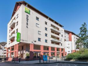 a large white building with a sign on it at ibis Styles Annecy Centre Gare in Annecy