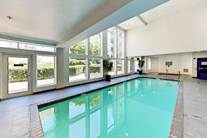 a large swimming pool in a building with windows at Serenity of Belltown Court in Seattle