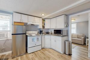 a kitchen with white cabinets and a refrigerator at Nancy's Villa in Hampton