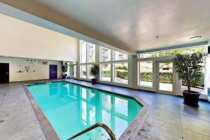 a large swimming pool in a building with windows at The Starry Night of Belltown in Seattle