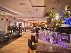 a restaurant with a bar sign in the middle at Novotel Santiago Vitacura in Santiago