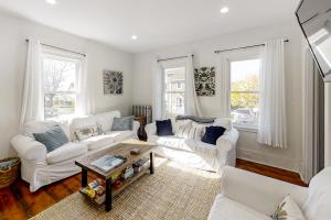 a living room with two white couches and a table at Boothbay Cottage in Boothbay Harbor