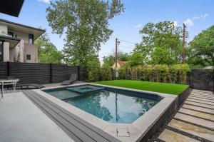 a swimming pool in a backyard with a fence at Heated Pool Luxury Zilker home Sleeps 8 great view in Austin