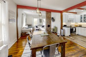 a kitchen and living room with a wooden table and chairs at Boothbay Cottage in Boothbay Harbor