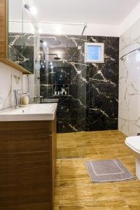a bathroom with a sink and a shower at Four lakes luxury suites in Amintaio +31 photos