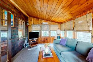 a living room with a couch and a tv at Big Cottage in Flaggs Trailer Park