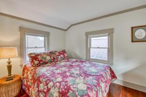 a bedroom with a bed and two windows at A Beautiful Carriage in Lake Junaluska