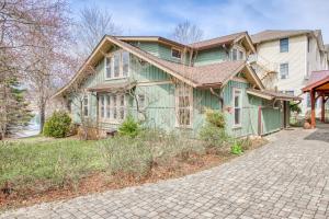 a green house with a brick driveway at A Beautiful Carriage in Lake Junaluska