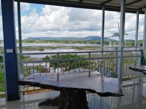 a table on a balcony with a view of a river at ชมวิว บึงโขงหลง in Bung Khong Long +24 photos