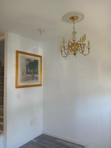 a chandelier hanging on a wall with a picture at Labelle in Wilkes-Barre +4 photos