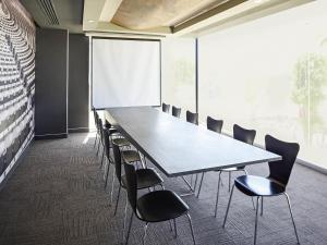 a conference room with a long table and chairs at Ibis Culiacan in Culiacán
