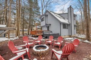 a group of chairs and a fire pit in front of a house at Private Pocono Retreat with Hot Tub and Fire Pit in Thornhurst