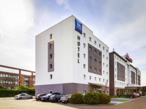 a white building with a sign on it at ibis Budget Luxembourg Aeroport in Luxembourg